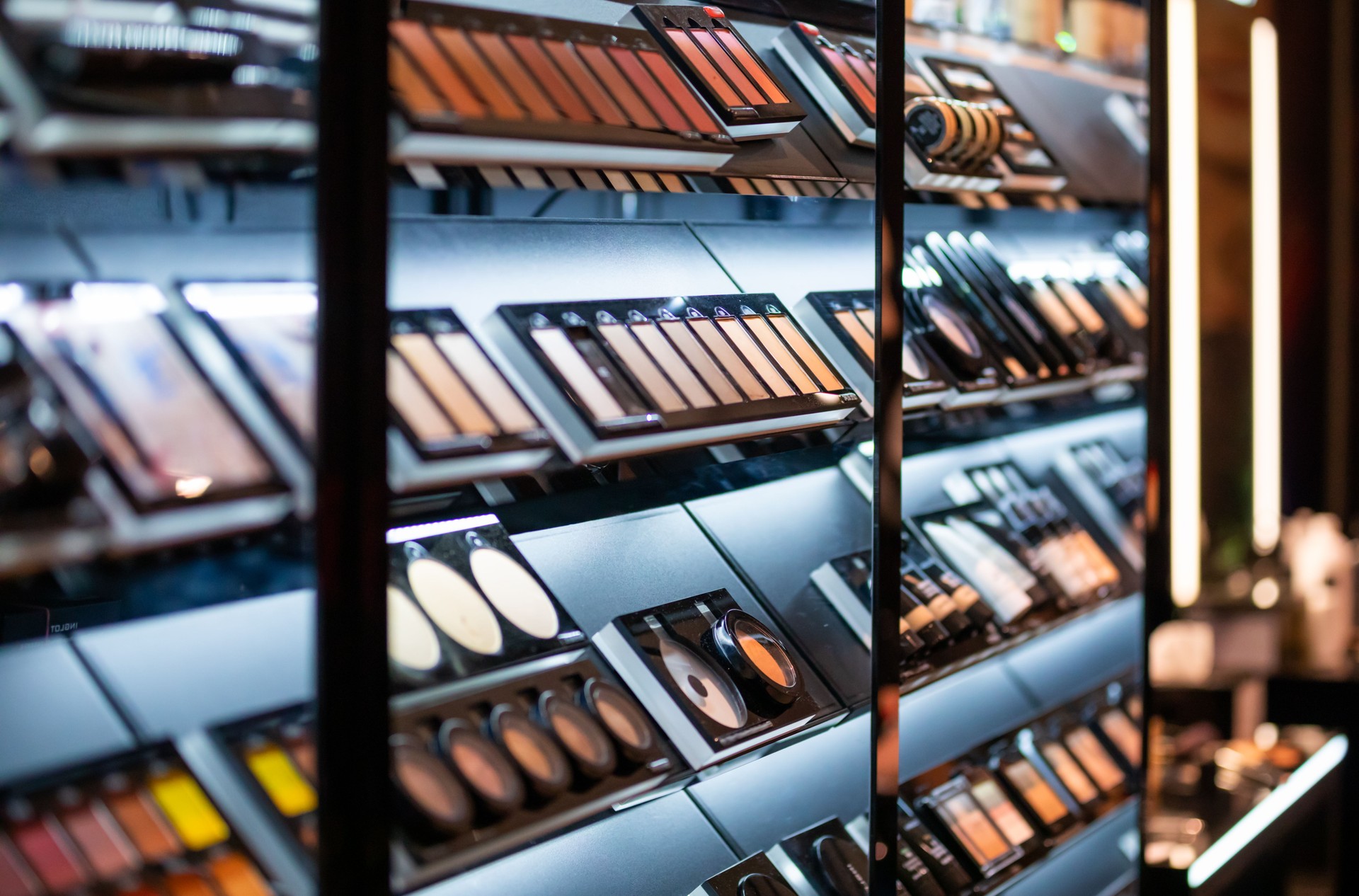 Set of cosmetics on shelves in beauty store