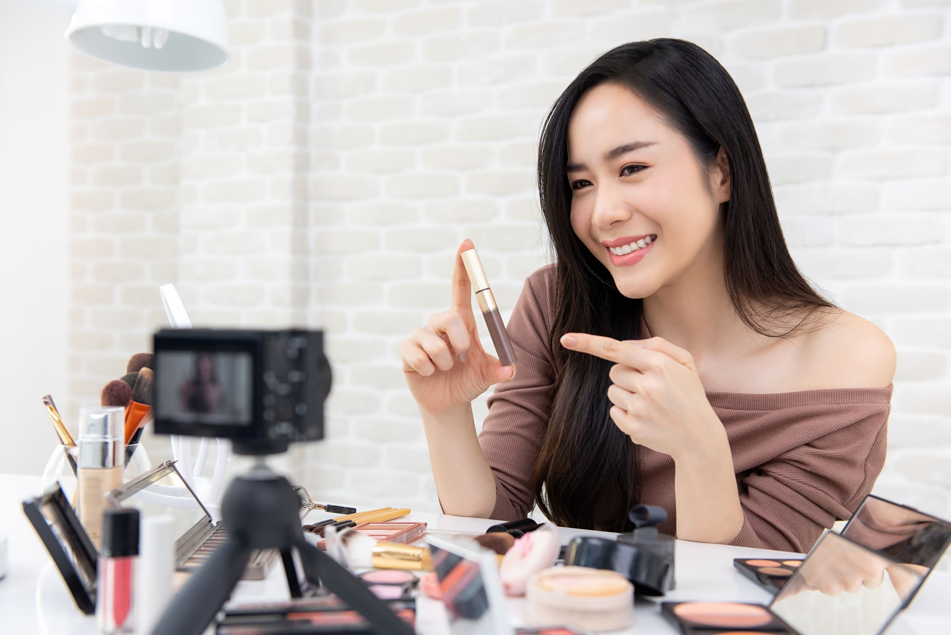 Asian woman beauty vlogger recording makeup review